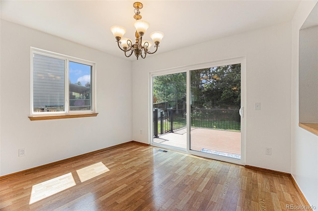 9346 Lark Sparrow Dr, Highlands Ranch, CO 80126 - unfurnished room with a chandelier, wood finished floors, and baseboards