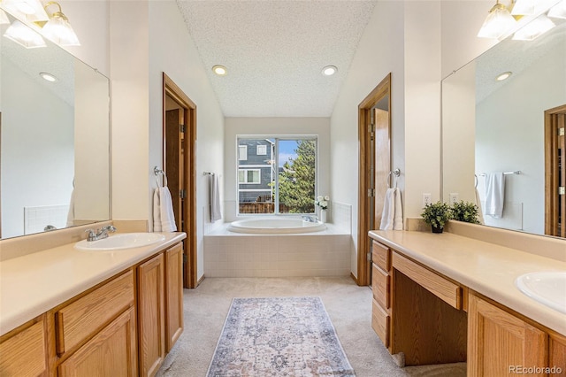 9346 Lark Sparrow Dr, Highlands Ranch, CO 80126 - bathroom featuring two vanities, a garden tub, a textured ceiling, and recessed lighting