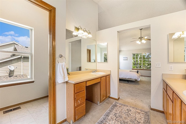 9346 Lark Sparrow Dr, Highlands Ranch, CO 80126 - bathroom featuring lofted ceiling, two vanities, ceiling fan, baseboards, and ensuite bathroom