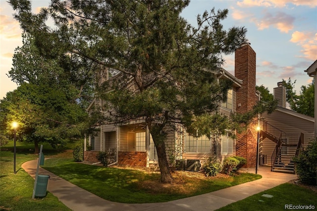 13824 E Lehigh Ave Unit B, Aurora, CO 80014 - view of front facade featuring brick siding, stairs, and a front yard