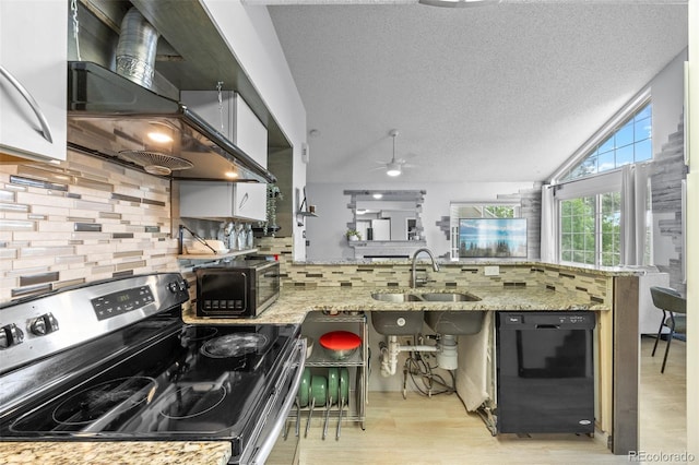 13824 E Lehigh Ave Unit B, Aurora, CO 80014 - kitchen with black appliances, a sink, a peninsula, wall chimney range hood, and decorative backsplash