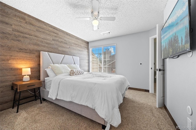 13824 E Lehigh Ave Unit B, Aurora, CO 80014 - carpeted bedroom with wooden walls, a textured ceiling, a ceiling fan, and baseboards