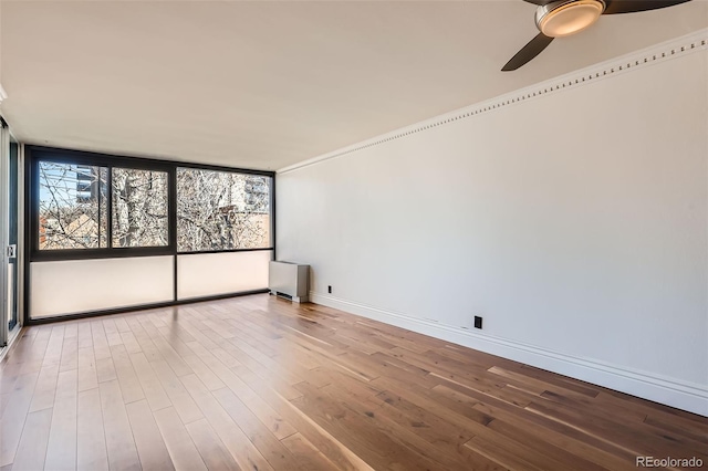 1050 N Corona St Unit 308, Denver, CO 80218 - unfurnished room with ceiling fan, wood finished floors, and baseboards