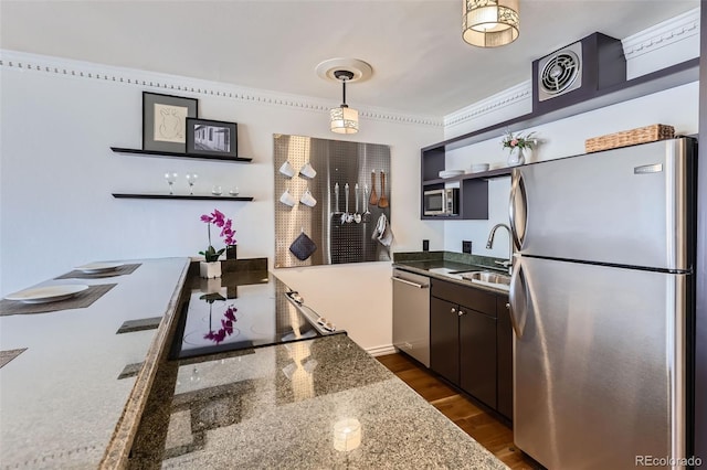 1050 N Corona St Unit 308, Denver, CO 80218 - kitchen with appliances with stainless steel finishes, a sink, dark wood-type flooring, hanging light fixtures, and dark brown cabinetry