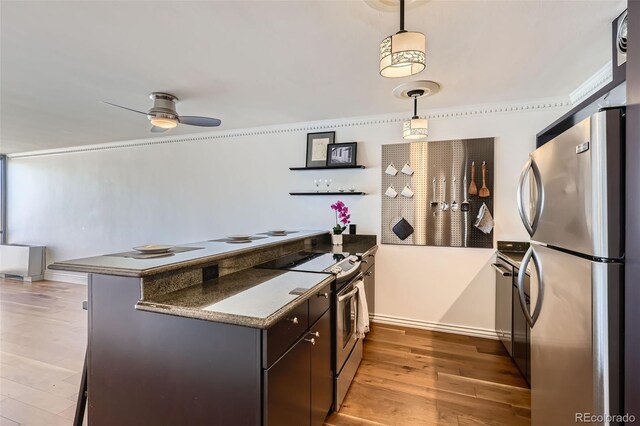 1050 N Corona St Unit 308, Denver, CO 80218 - kitchen with stainless steel appliances, a peninsula, light wood-style flooring, pendant lighting, and ceiling fan