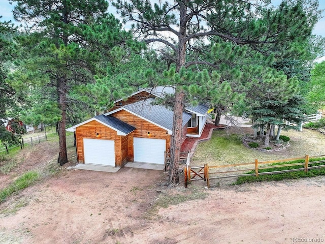 1539 Bluebird Dr, Bailey, CO 80421 - view of front facade featuring a garage, driveway, and an outbuilding