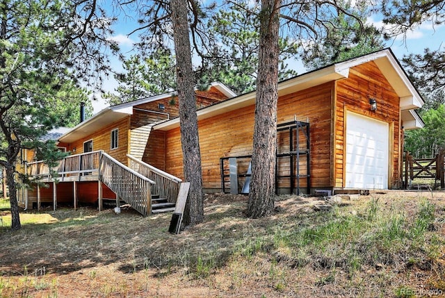 1539 Bluebird Dr, Bailey, CO 80421 - view of home's exterior featuring a wooden deck, a garage, and stairway