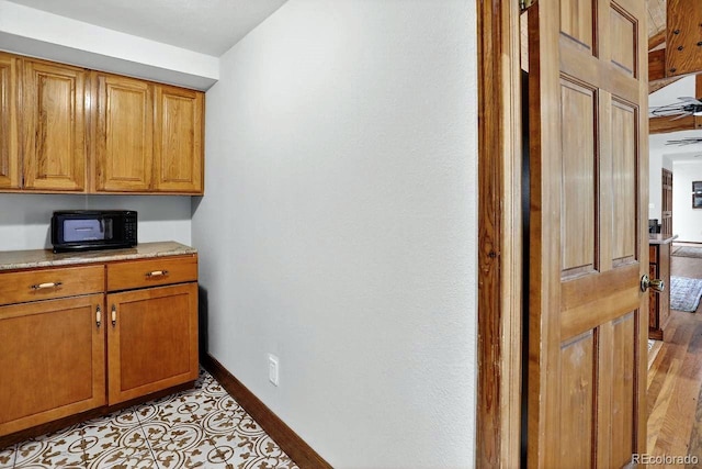 1539 Bluebird Dr, Bailey, CO 80421 - kitchen featuring black microwave and brown cabinetry