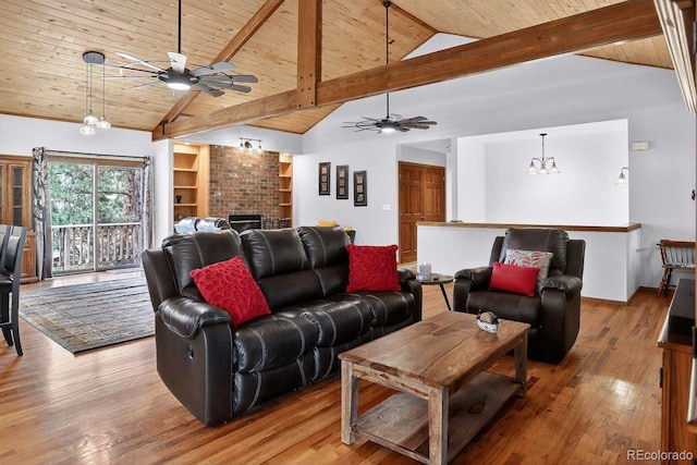 1539 Bluebird Dr, Bailey, CO 80421 - living room featuring ceiling fan, a wood ceiling with exposed beams, a fireplace, wood finished floors, and a chandelier