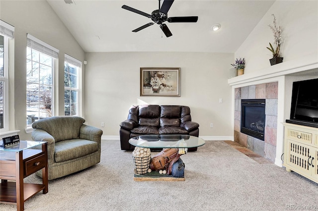 living room featuring carpet floors, a fireplace, baseboards, and vaulted ceiling