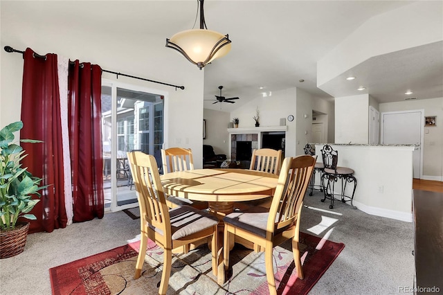 carpeted dining space featuring visible vents, baseboards, a ceiling fan, a tile fireplace, and recessed lighting