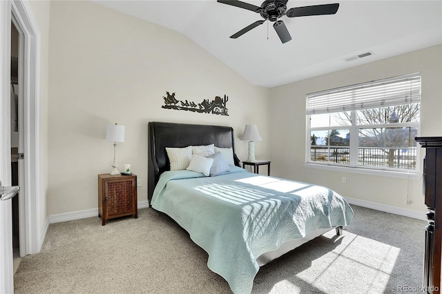 bedroom featuring lofted ceiling, baseboards, visible vents, and carpet