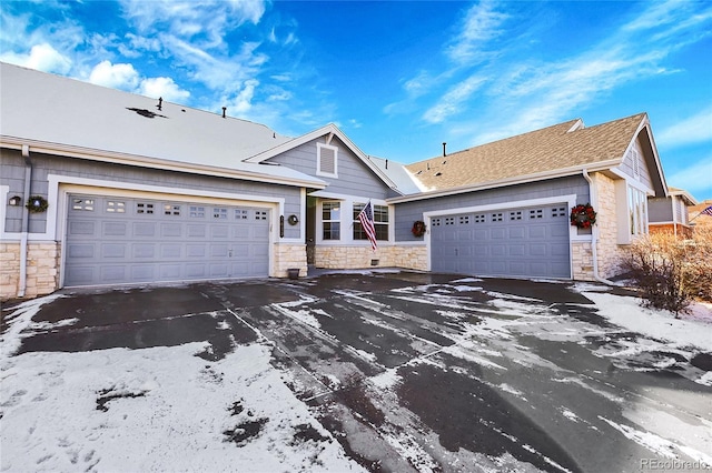 view of front of home with stone siding and an attached garage