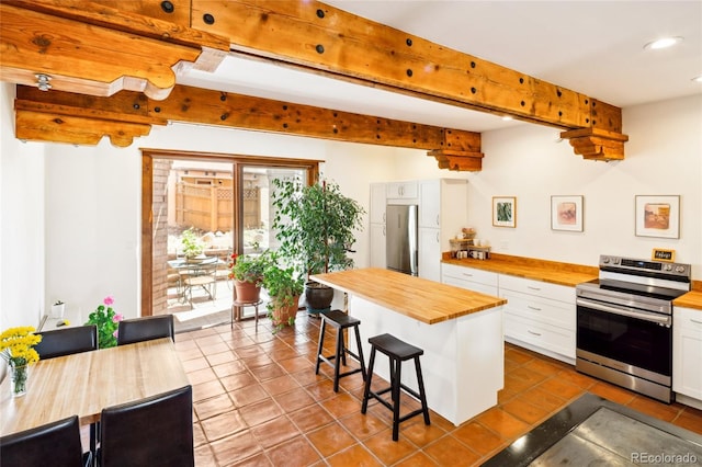 11 Baca Mdws, Moffat, CO 81131 - kitchen featuring wood counters, appliances with stainless steel finishes, white cabinets, a kitchen bar, and recessed lighting