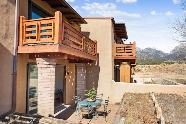 11 Baca Mdws, Moffat, CO 81131 - view of home's exterior with a balcony, a mountain view, stucco siding, and a patio