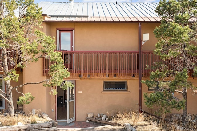11 Baca Mdws, Moffat, CO 81131 - view of side of property featuring a standing seam roof, a balcony, and stucco siding