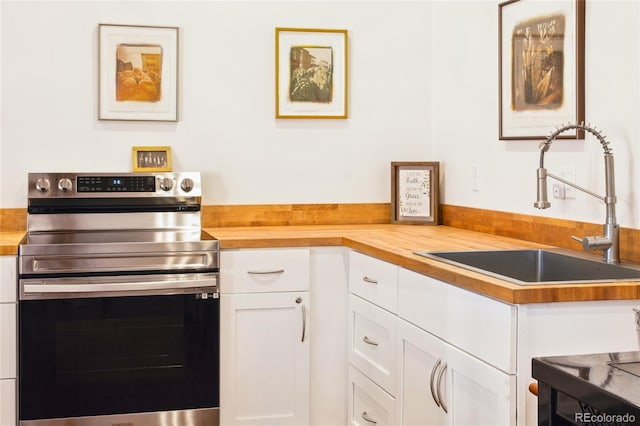 11 Baca Mdws, Moffat, CO 81131 - kitchen with stainless steel electric range, butcher block countertops, and white cabinets