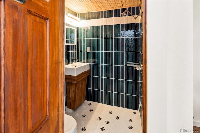 11 Baca Mdws, Moffat, CO 81131 - full bathroom featuring tile patterned floors, tiled shower, tile walls, and vanity