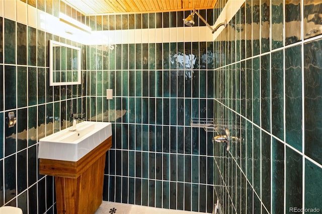 11 Baca Mdws, Moffat, CO 81131 - bathroom featuring a tile shower, vanity, and tile walls