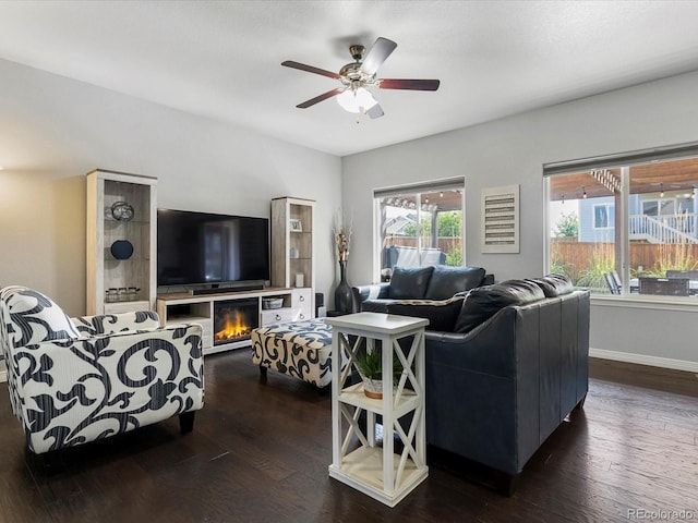 6832 Sequoia St, Frederick, CO 80530 - living room featuring ceiling fan, dark wood-type flooring, and a glass covered fireplace