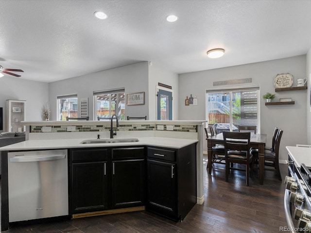6832 Sequoia St, Frederick, CO 80530 - kitchen featuring stainless steel appliances, open floor plan, light countertops, dark cabinetry, and a ceiling fan
