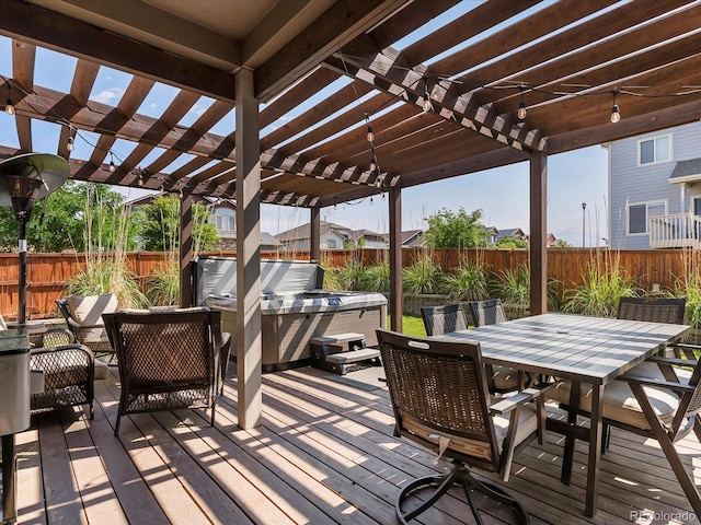 6832 Sequoia St, Frederick, CO 80530 - wooden terrace featuring a pergola, a hot tub, outdoor dining area, and a fenced backyard