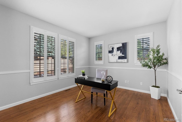 office area with baseboards and wood finished floors