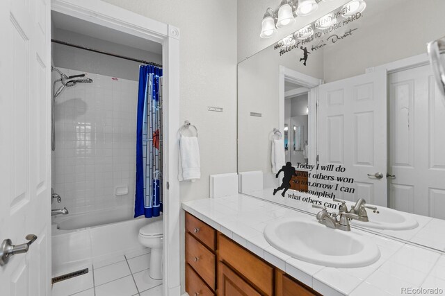bathroom with vanity, tile patterned floors, shower / bath combo, and toilet