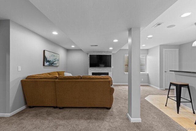 living room with light colored carpet, a fireplace, recessed lighting, baseboards, and visible vents