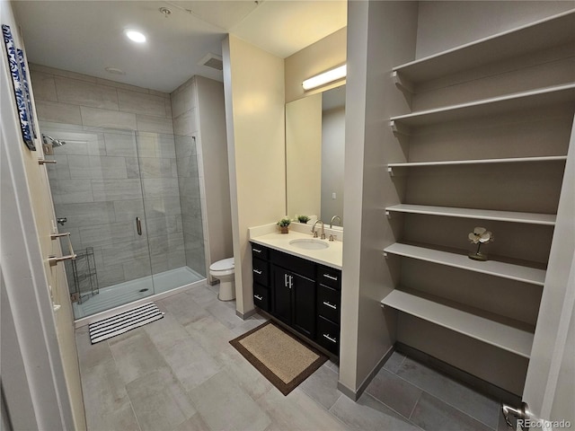 bathroom featuring toilet, a stall shower, vanity, and recessed lighting