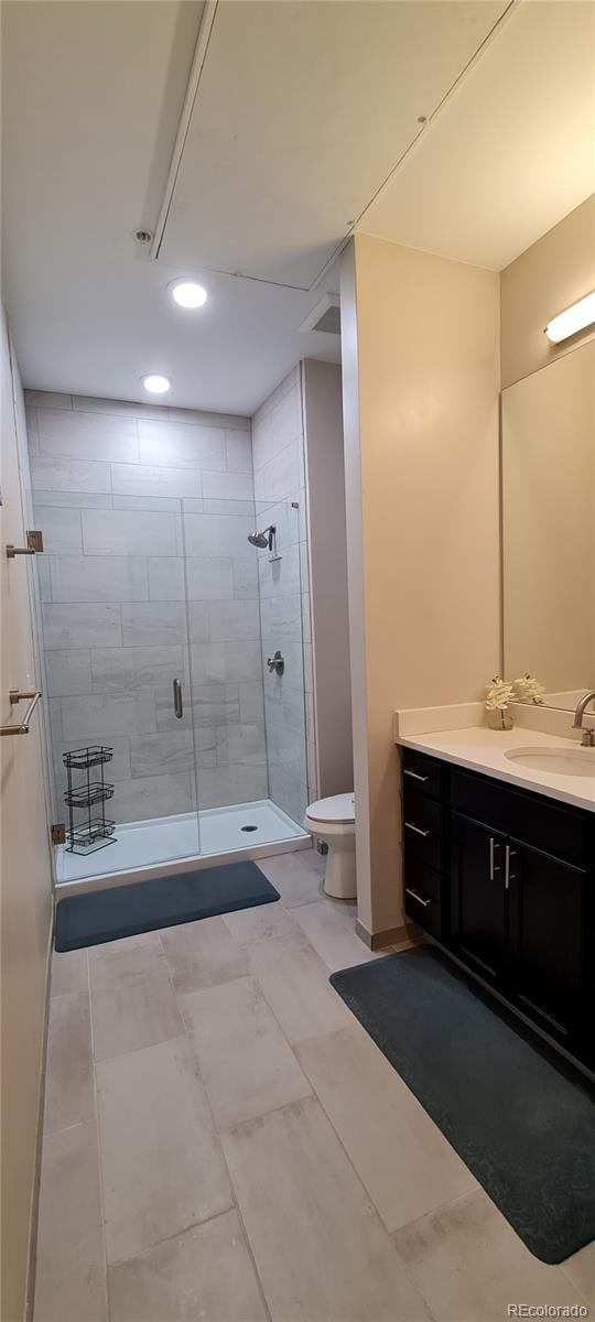 full bathroom featuring toilet, a shower stall, vanity, and recessed lighting