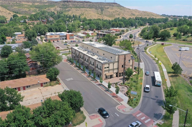 aerial view of property and surrounding area featuring a mountain backdrop