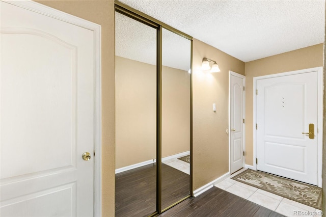 1020 15th St Unit 16A, Denver, CO 80202 - entrance foyer with a textured ceiling, wood finished floors, and baseboards
