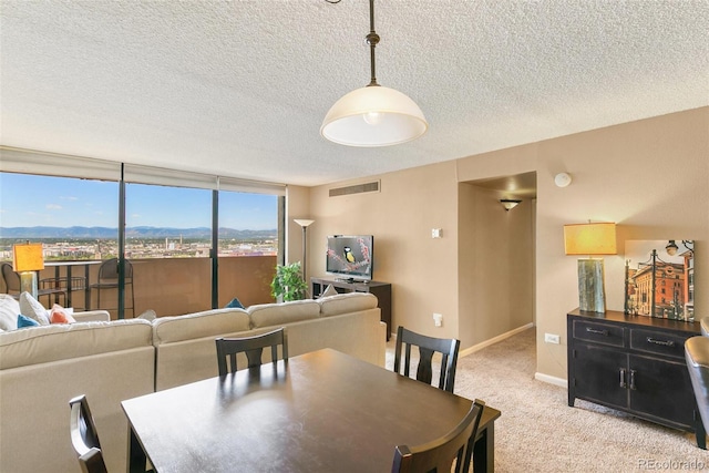 1020 15th St Unit 16A, Denver, CO 80202 - dining room featuring a textured ceiling, light colored carpet, and baseboards
