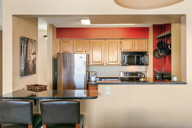 1020 15th St Unit 16A, Denver, CO 80202 - kitchen featuring black microwave, freestanding refrigerator, range, and a peninsula