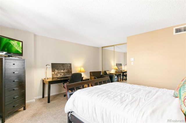 1020 15th St Unit 16A, Denver, CO 80202 - bedroom featuring light colored carpet, a desk, a closet, a textured ceiling, and baseboards