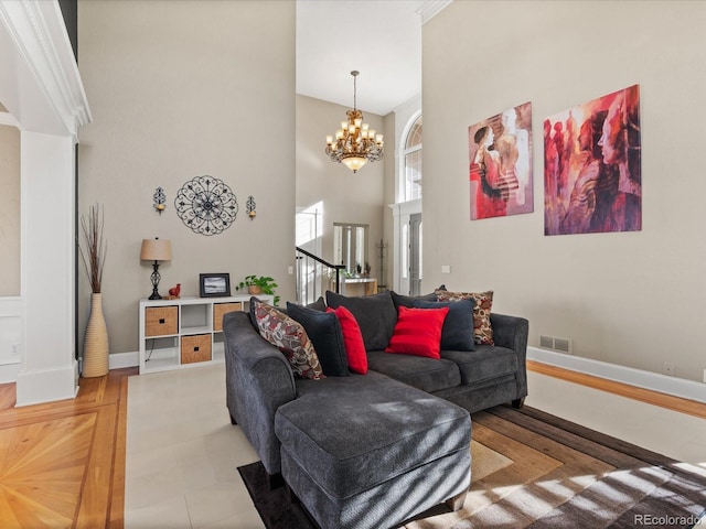 living room with a chandelier and a towering ceiling