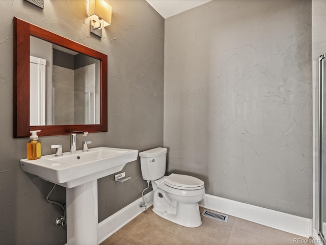 bathroom with sink, tile patterned flooring, and toilet