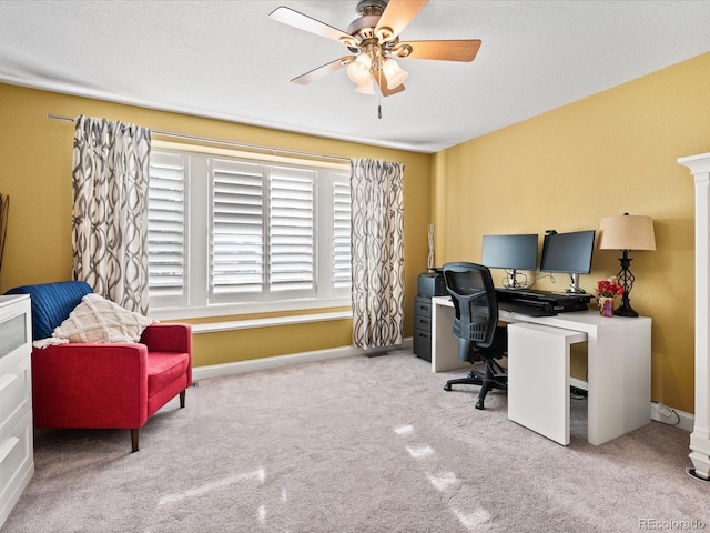 carpeted office space featuring ceiling fan