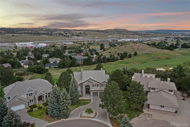 aerial view at dusk featuring a residential view