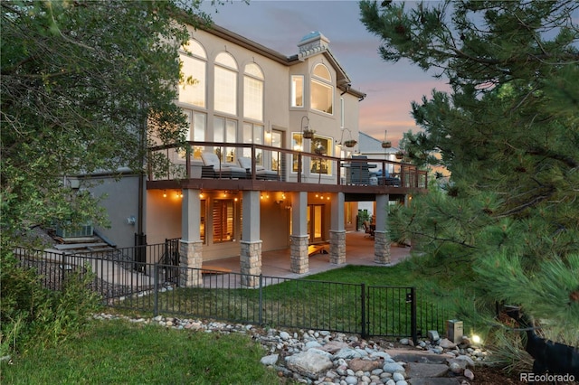 back of house featuring a patio, fence private yard, and stucco siding