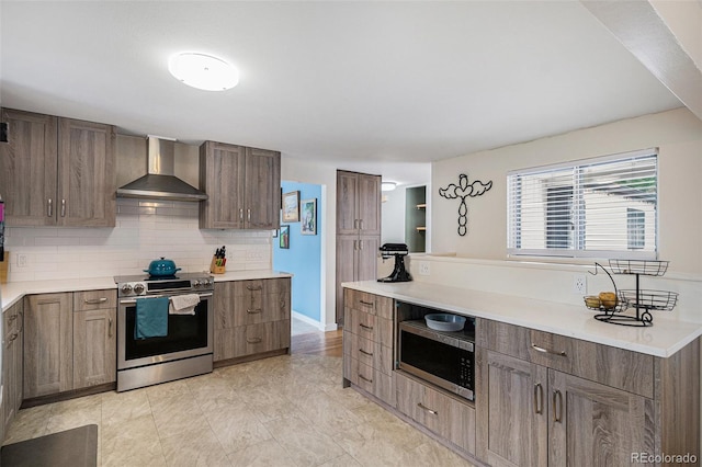 6898 S Franklin Cir, Centennial, CO 80122 - kitchen with stainless steel appliances, wall chimney range hood, decorative backsplash, and light countertops