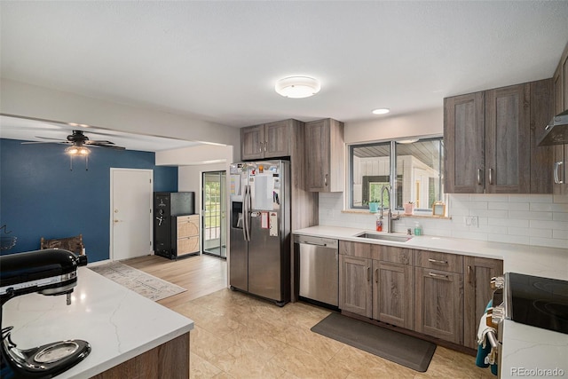 6898 S Franklin Cir, Centennial, CO 80122 - kitchen with stainless steel appliances, backsplash, a ceiling fan, and light stone counters