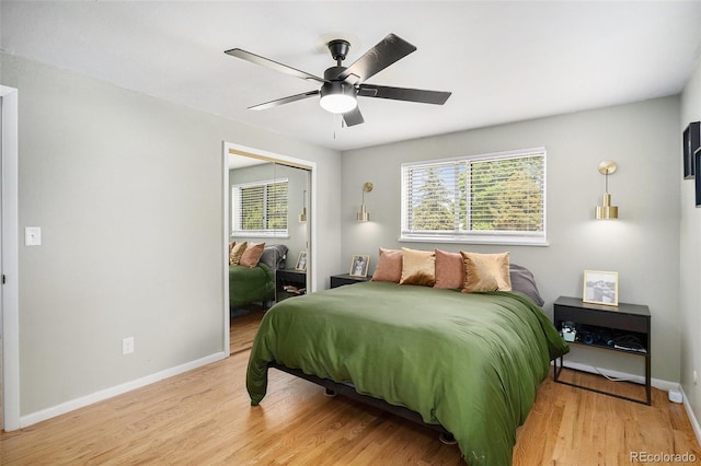 6898 S Franklin Cir, Centennial, CO 80122 - bedroom with multiple windows, wood finished floors, a closet, and a ceiling fan