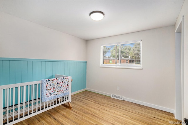6898 S Franklin Cir, Centennial, CO 80122 - bedroom with wood finished floors and a wainscoted wall