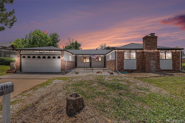 6898 S Franklin Cir, Centennial, CO 80122 - ranch-style house featuring a garage, concrete driveway, brick siding, and a chimney