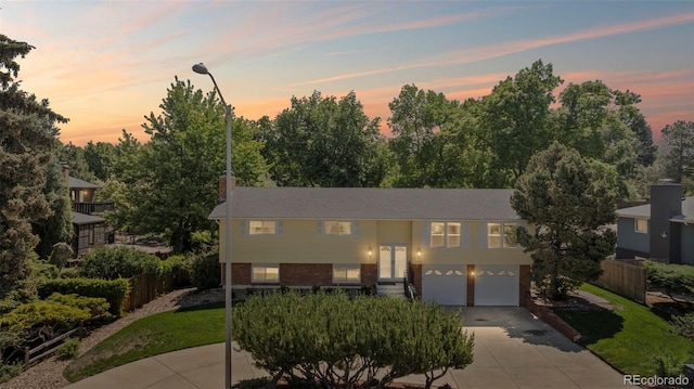 2315 N Murray Blvd, Colorado Springs, CO 80915 - view of front of house with an attached garage, concrete driveway, and brick siding