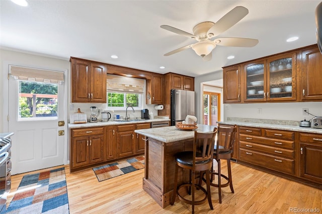 2315 N Murray Blvd, Colorado Springs, CO 80915 - kitchen featuring freestanding refrigerator, light wood-style flooring, recessed lighting, ceiling fan, and a breakfast bar area