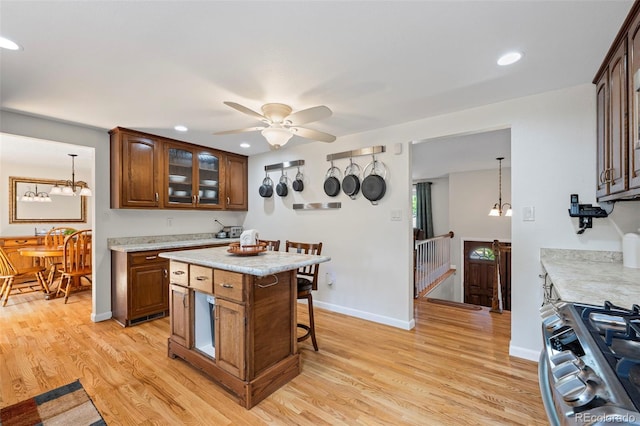 2315 N Murray Blvd, Colorado Springs, CO 80915 - kitchen with stainless steel stove, light countertops, light wood-style flooring, recessed lighting, and a breakfast bar