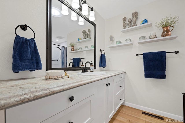 2315 N Murray Blvd, Colorado Springs, CO 80915 - full bath featuring vanity, wood finished floors, and curtained shower
